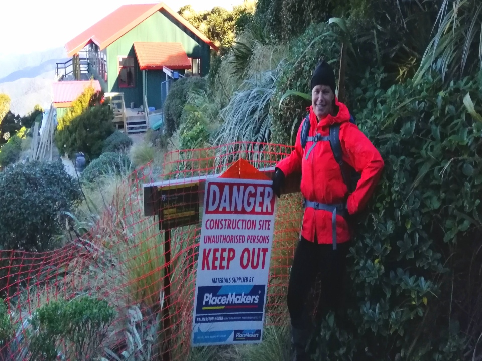 Tramper standing near a construction sign for Powell Hut