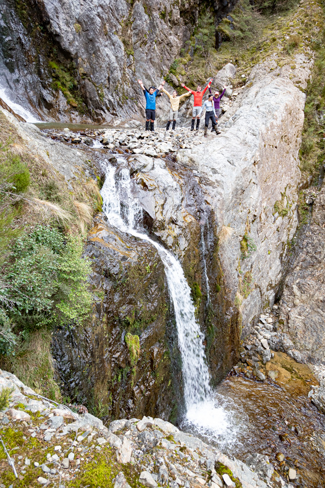 People standing on the edge of the high level waterfall pool