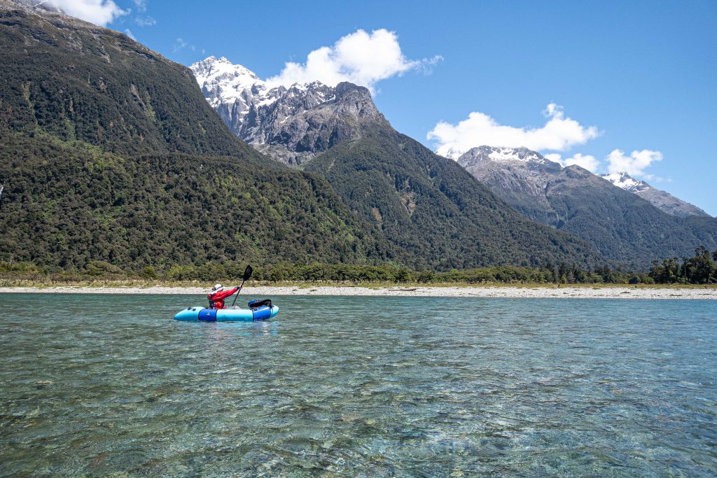 Paddling down the Hollyford River with spectacular scenery of the Darran Mountains