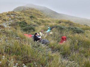 Jamie, Anna, and Loretha enjoy a welcome late lunch - tucked in out of the wind just below the ridge