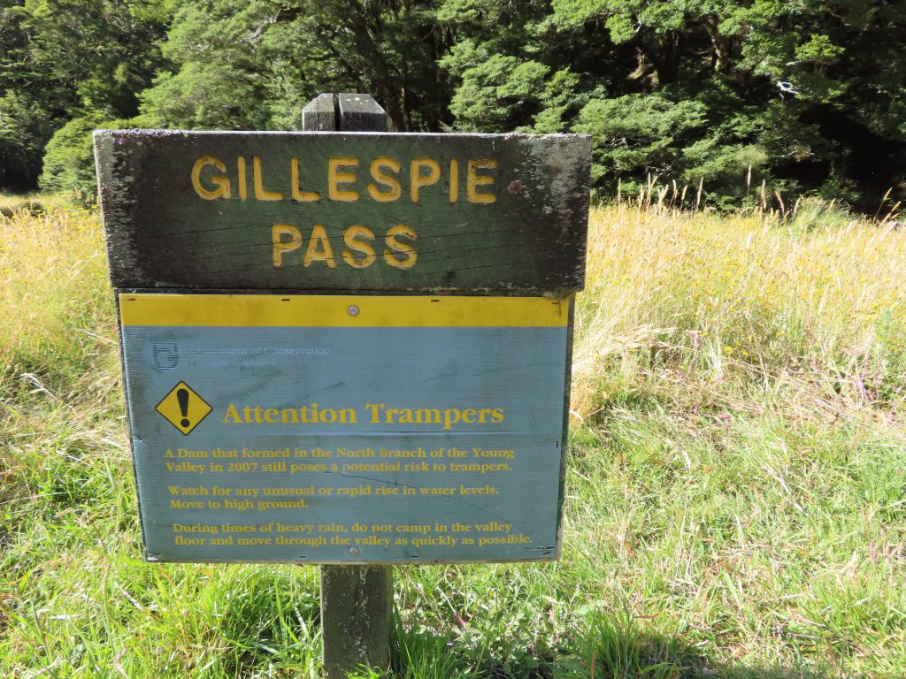 A sign for Gillespie Pass bearing a warning about a natural dam formed in 2007