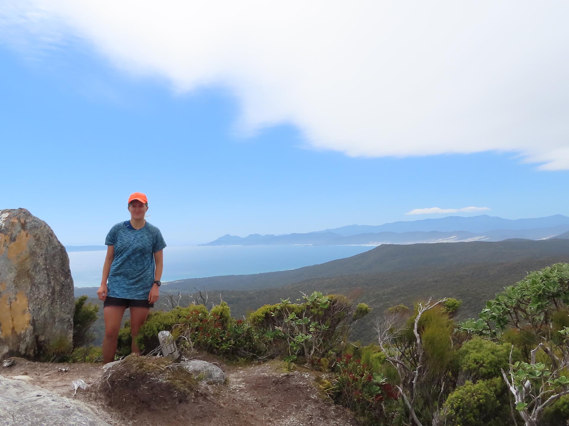 On the summit of Mt Adams with Mason Bay and the Ruggedy Range visible in the distance