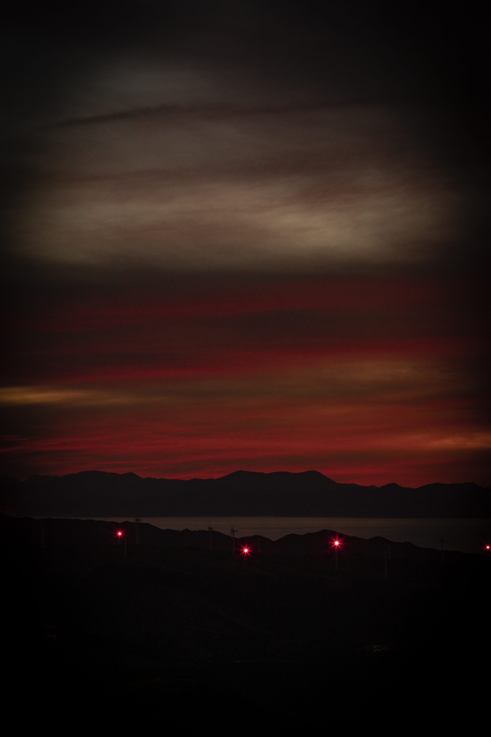 The view west from Kaukau at night showing South Island and the wind turbine lights.