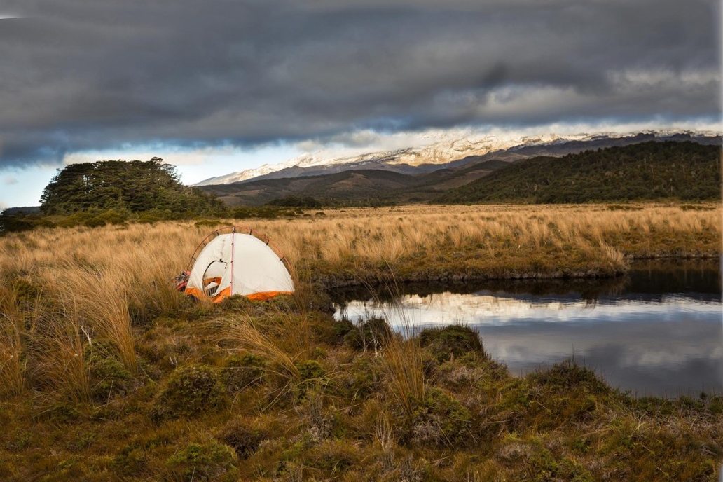 Camping by one of the many tarns. The lower slopes of Ruapehu behind.