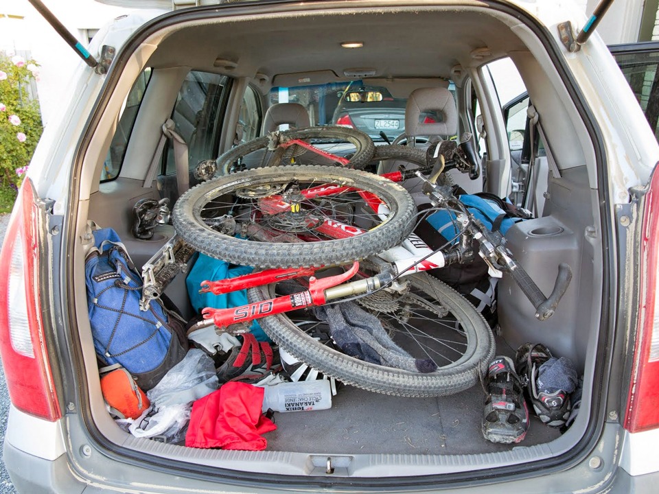Mountain bikes and other cycling gear crammed into a rental car
