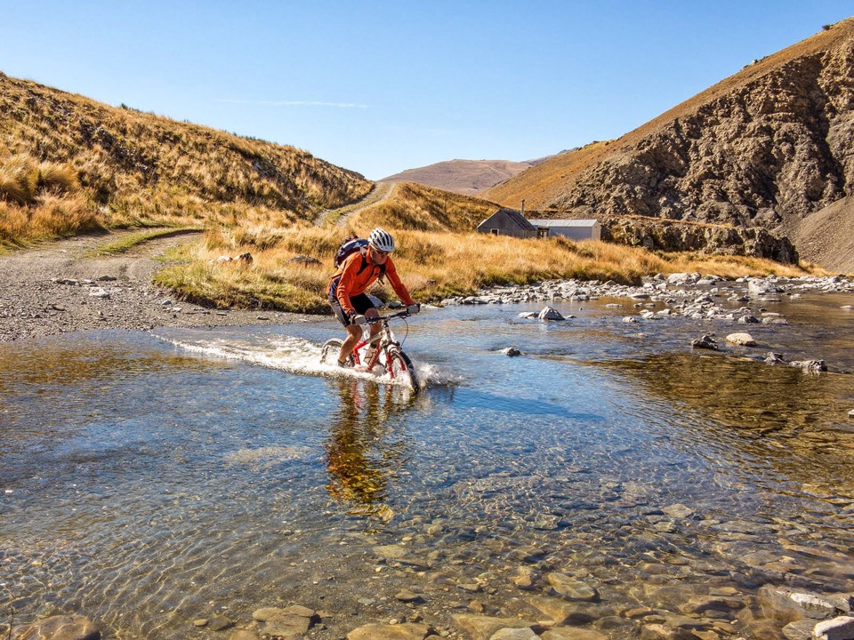 Otago mountain biking crossing a small stream