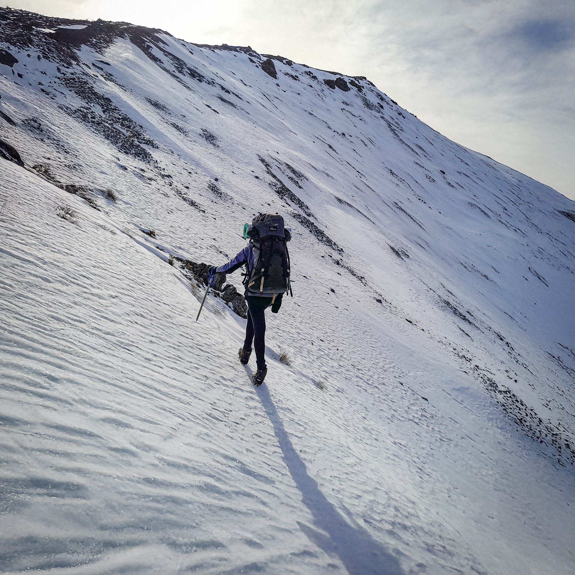Traversing snow slopes beneath Mt Bruce Cass-Lagoon Saddle Track